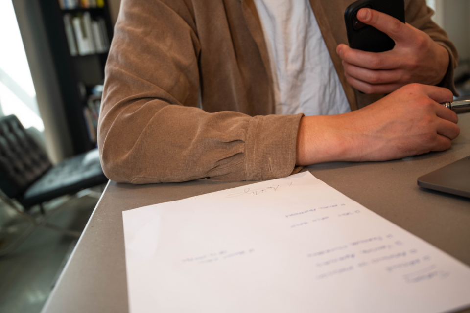 Person reviewing a document at a table